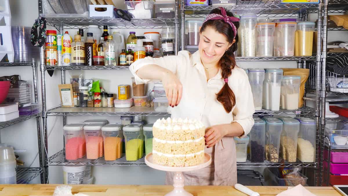 Jocelyn adding sprinkles to a rice krispie treat cake in the kitchen