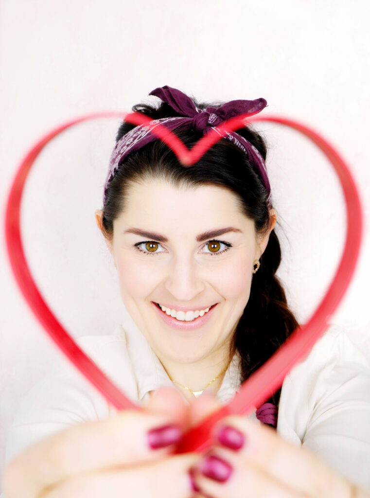 self portrait of Jocelyn holding a heart-shaped cookie cutter
