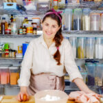 portrait of Jocelyn, the founder of MINT + MALLOW kitchen behind her work station in the bakery