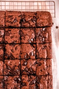 a full pan of fudgy gluten free brownies cut into squares on a wire cooling rack