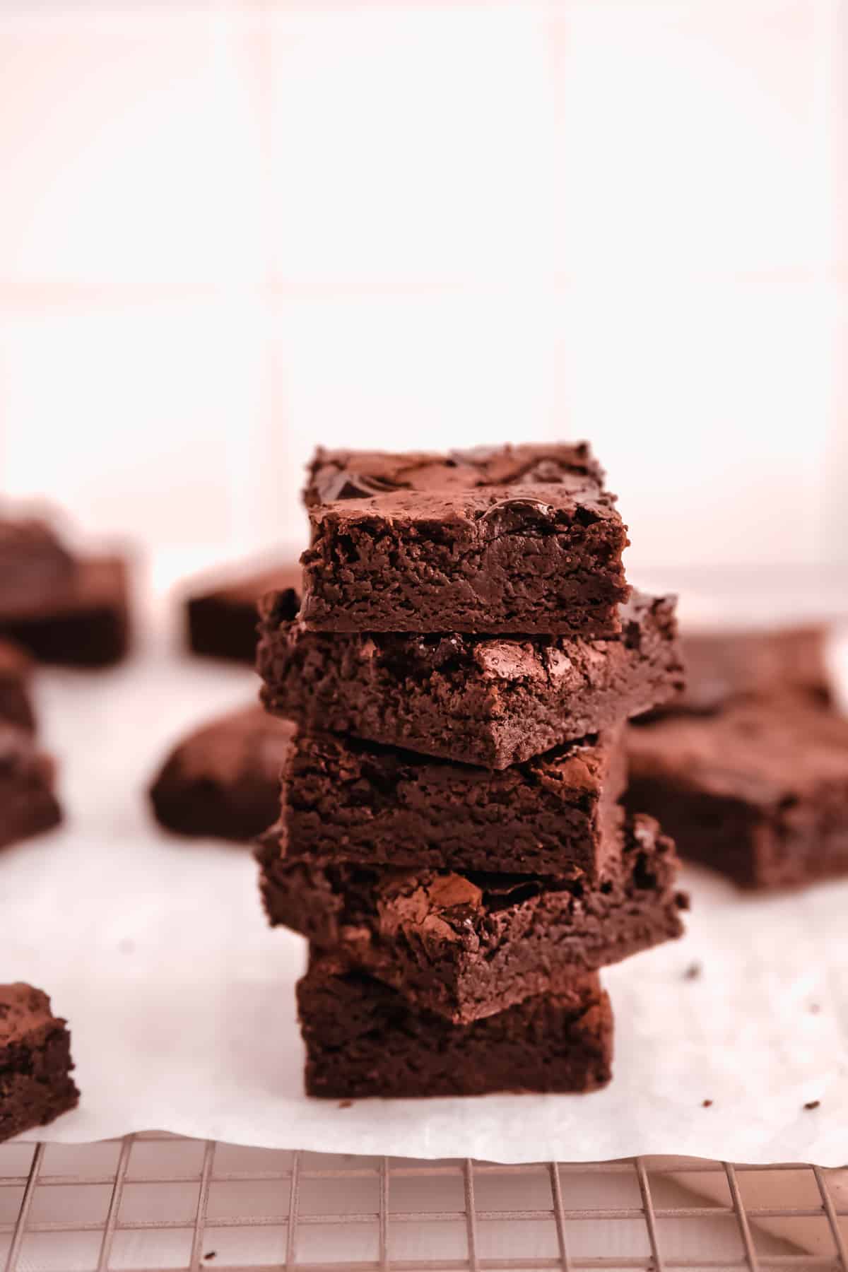 cut squares of fudgy gluten free brownies in a stack showing the fudgy texture