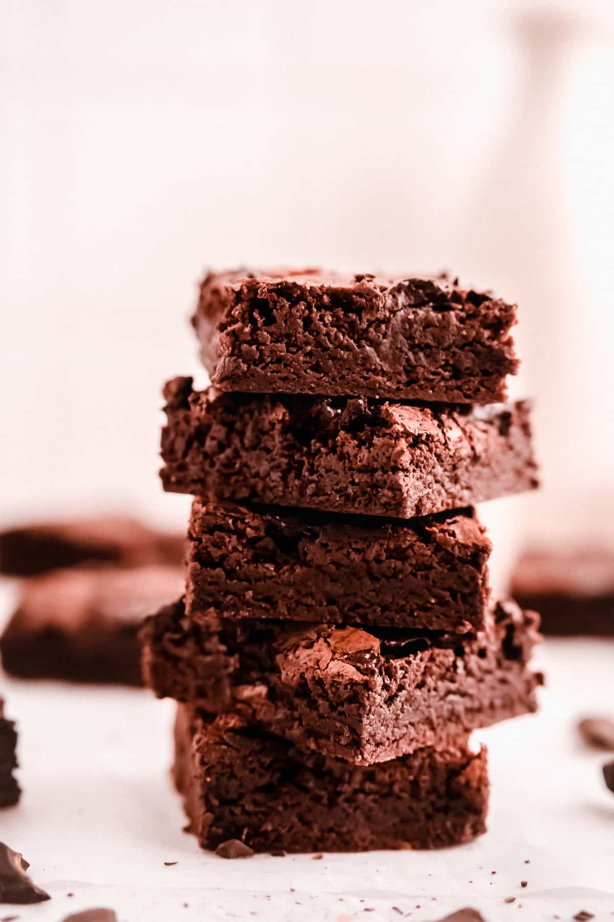 cut squares of fudgy gluten free brownies in a stack showing the fudgy texture