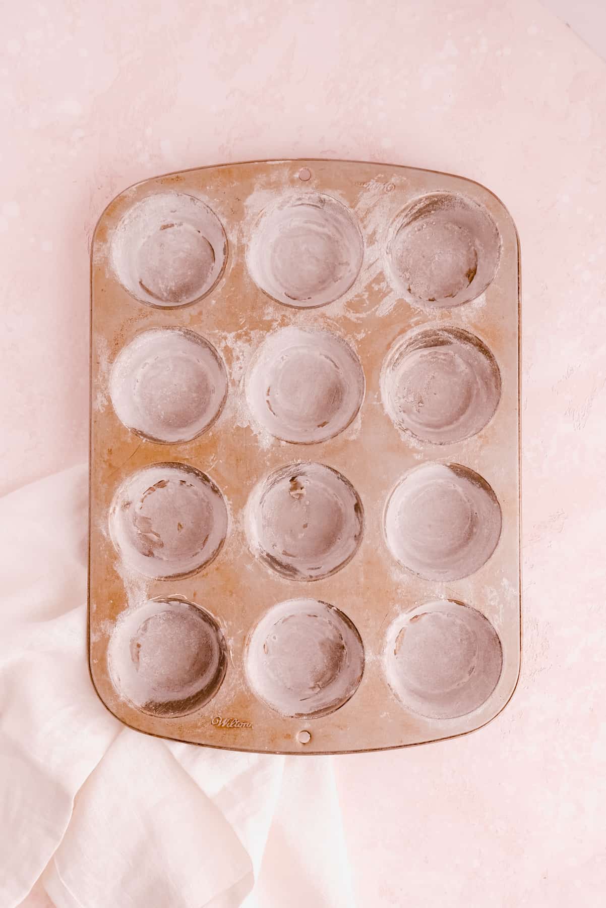 a buttered and floured cupcake pan for mini victoria sponge cakes