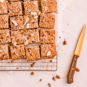 coconut butterscotch cookie bars on a wire rack