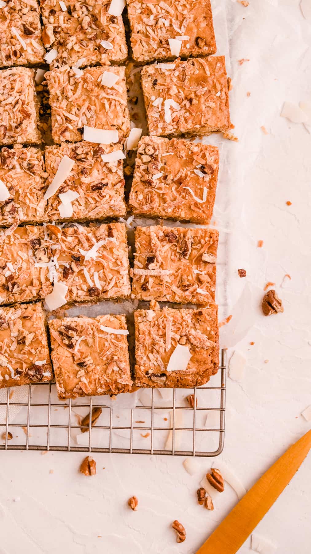 coconut butterscotch cookie bars on a wire rack