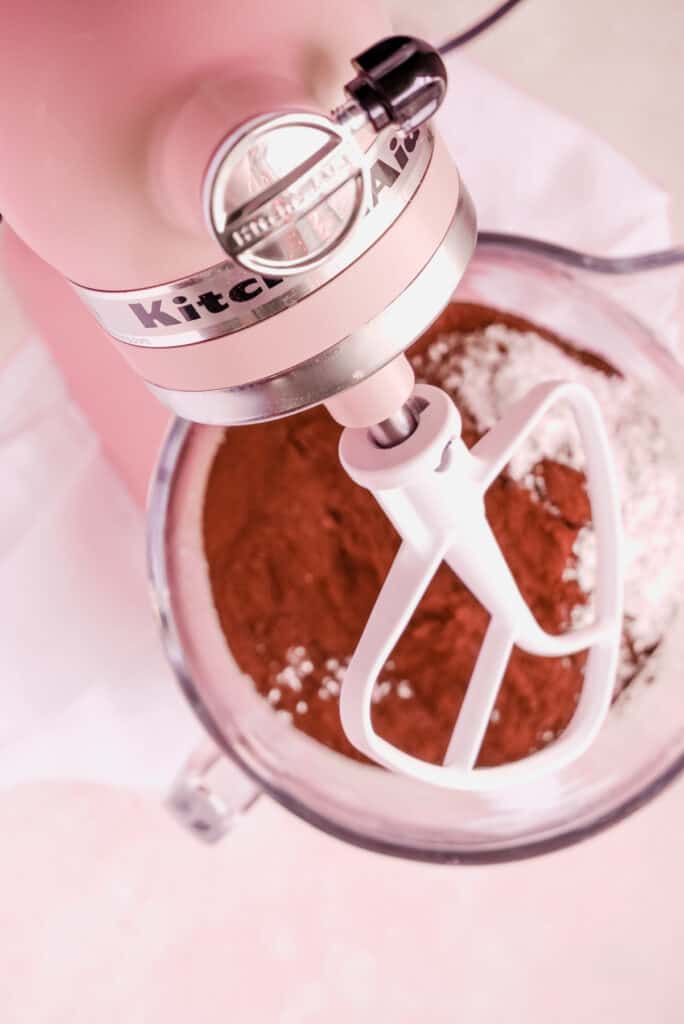 a bowl of chocolate buttercream frosting on a mixer