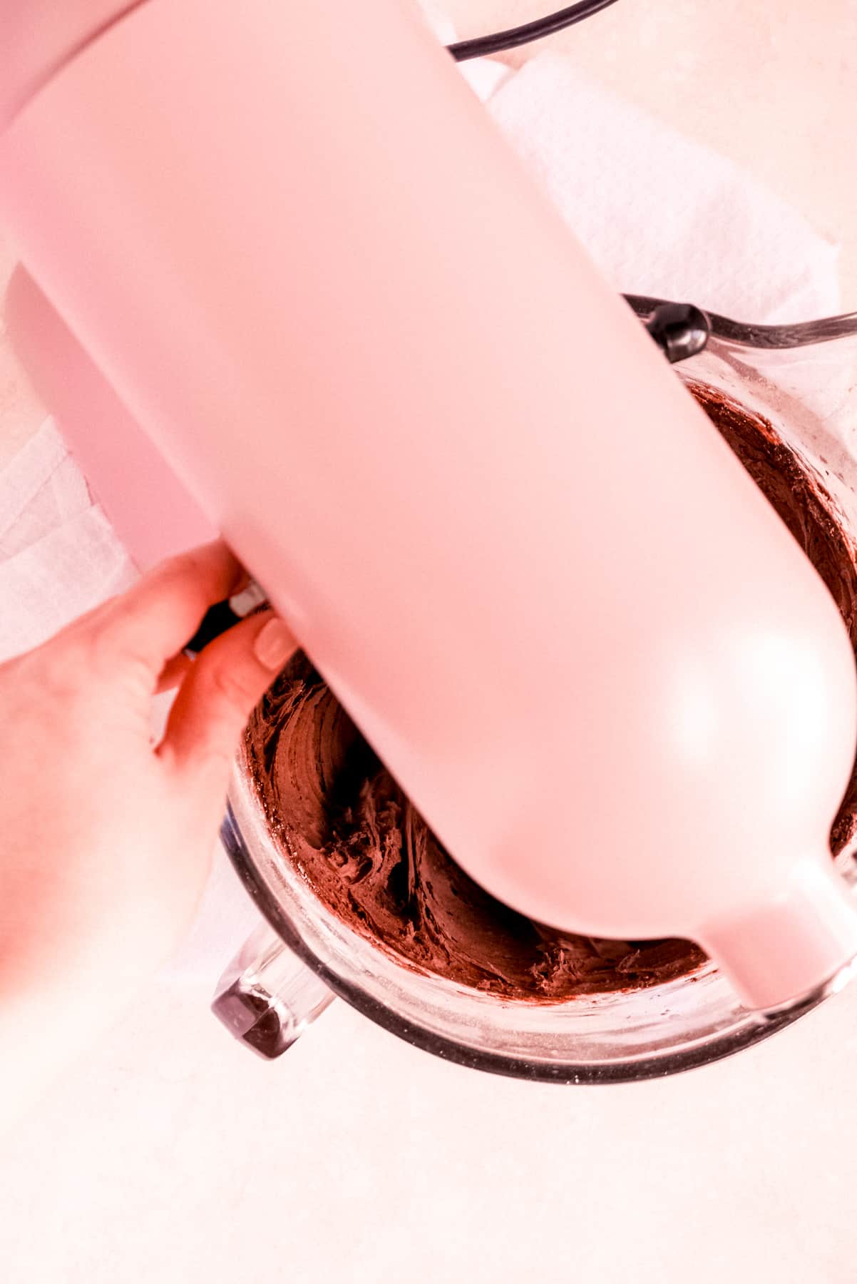 a bowl of chocolate buttercream frosting on a mixer
