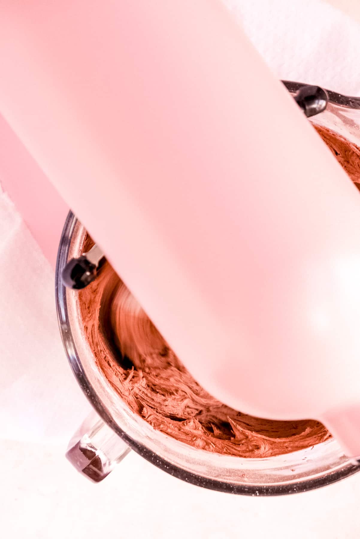 a bowl of chocolate buttercream frosting on a mixer