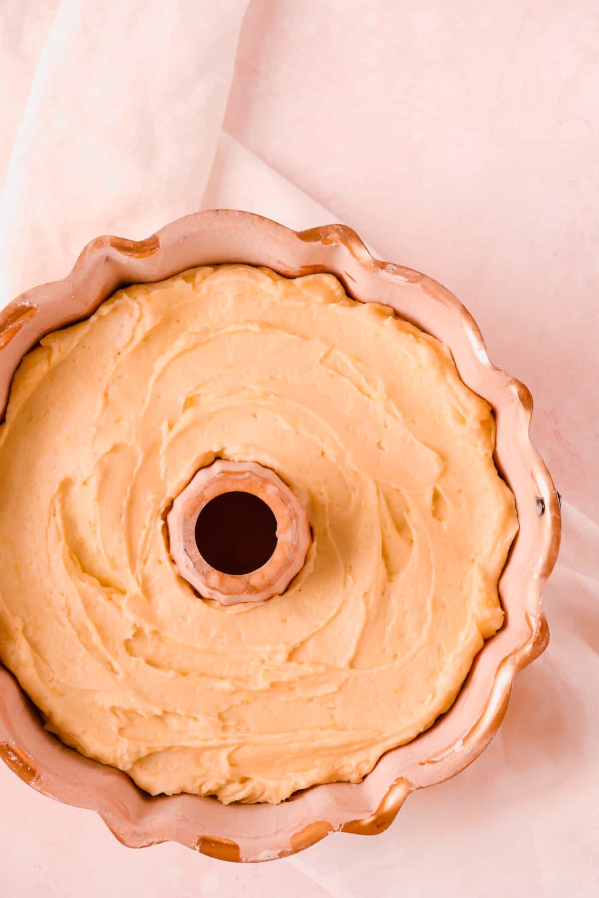 lemon bundt cake batter in a copper bundt pan.