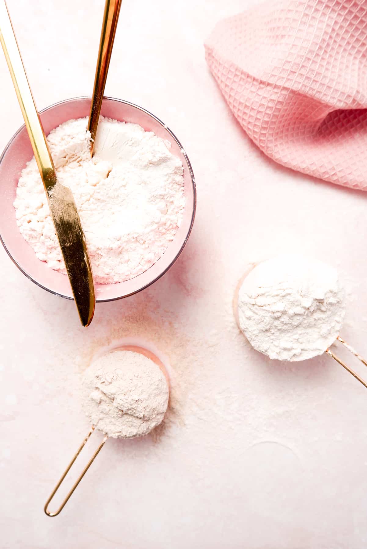 different types of flour in a bowl and measuring cups