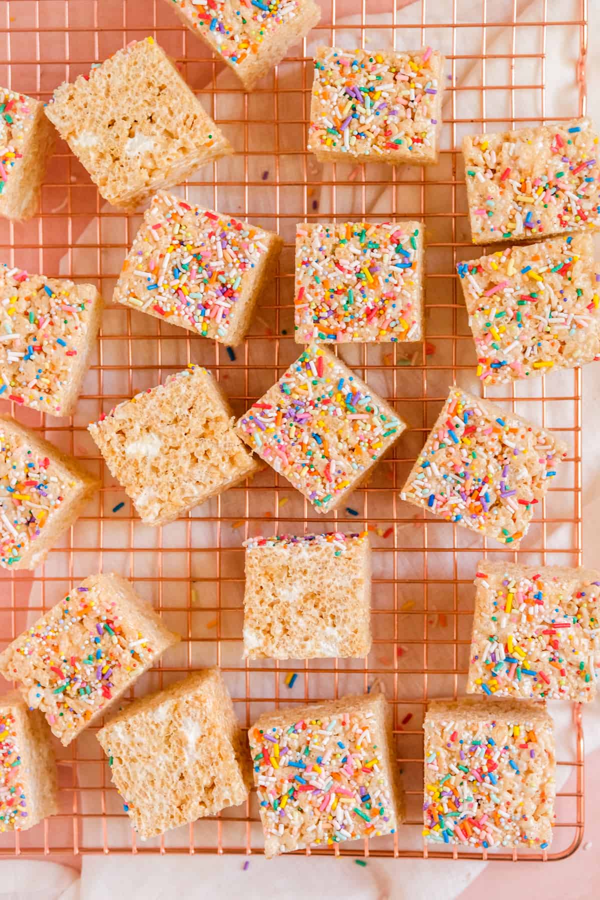 Brown Butter Rice Krispie Treats on a wire rack with sprinkles on top and some on the sides