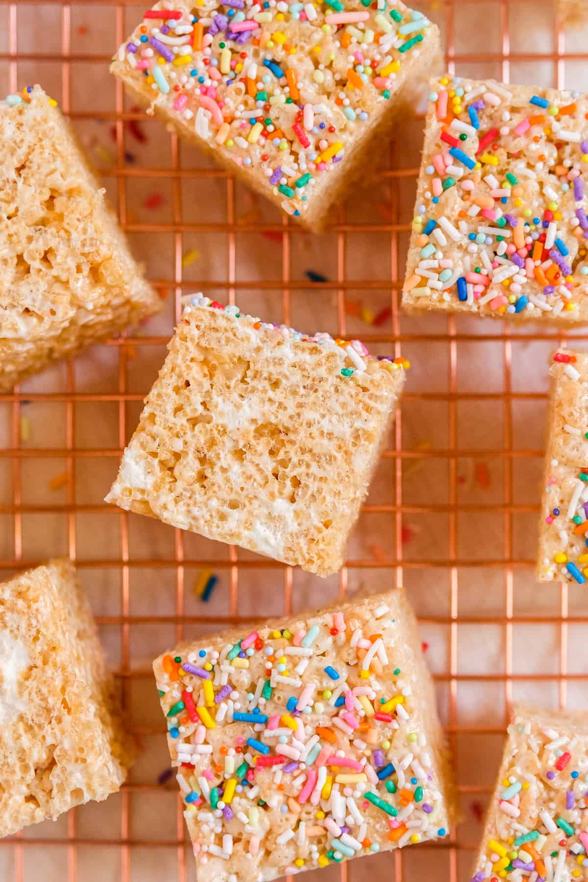 Brown Butter Rice Krispie Treats on a wire rack with sprinkles on top and some on the sides