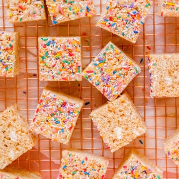 Brown Butter Rice Krispie Treats on a wire rack with sprinkles on top and some on the sides