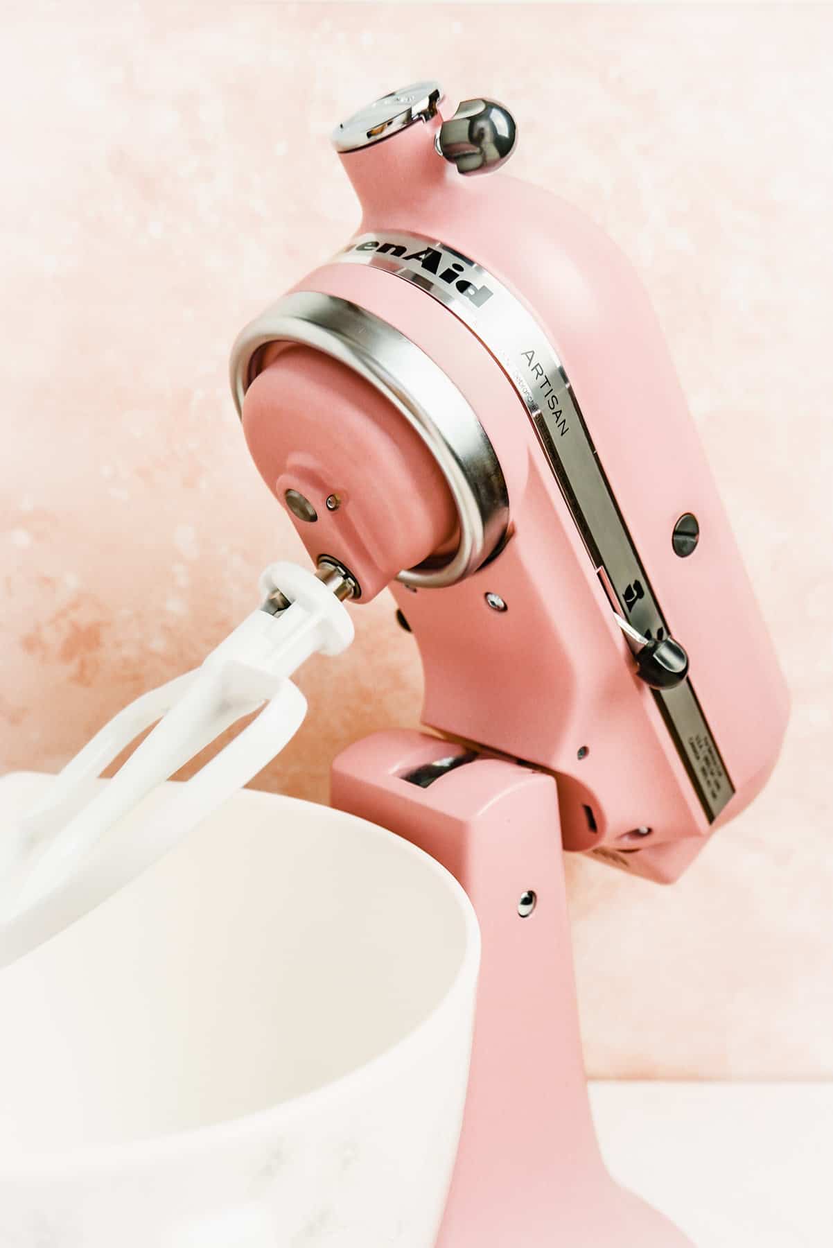empty pink kitchen aid stand mixer with its head tilted back