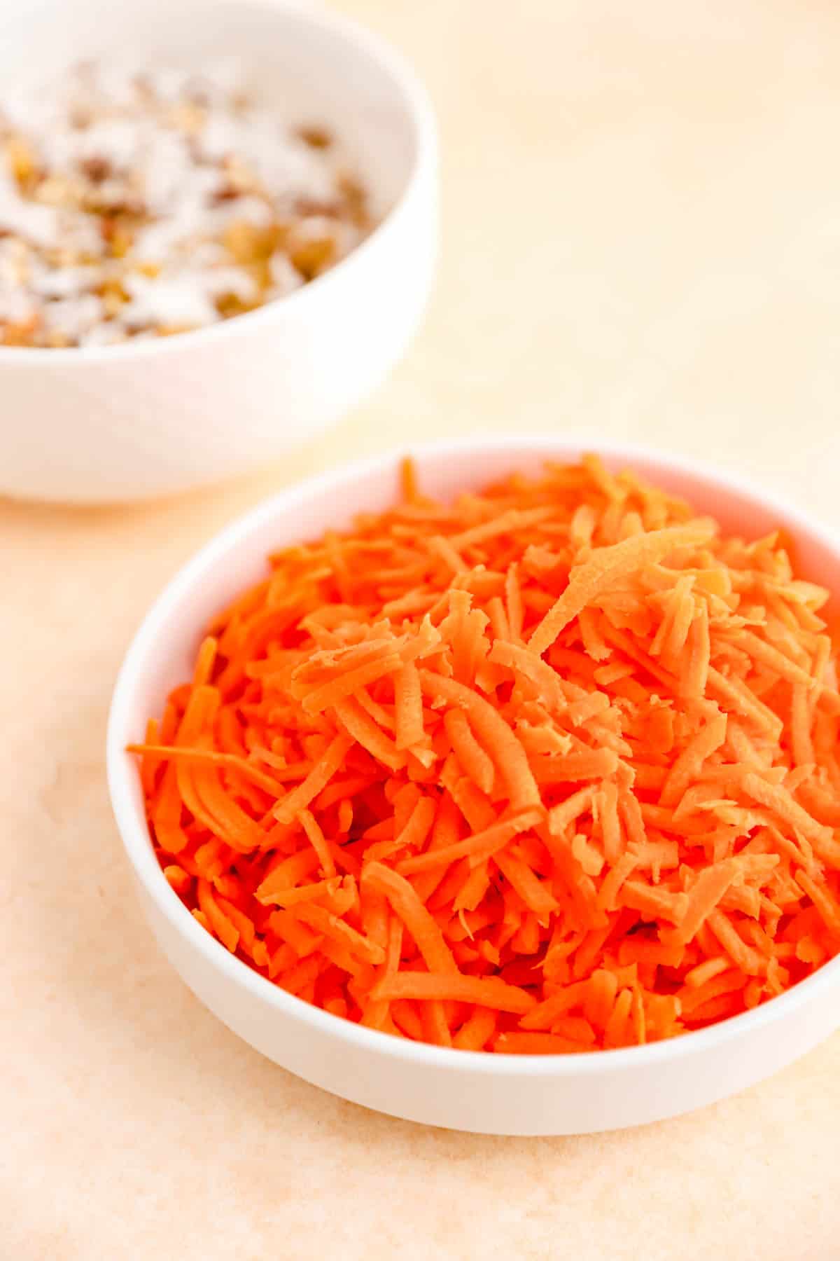 shredded carrot in a small white dish.