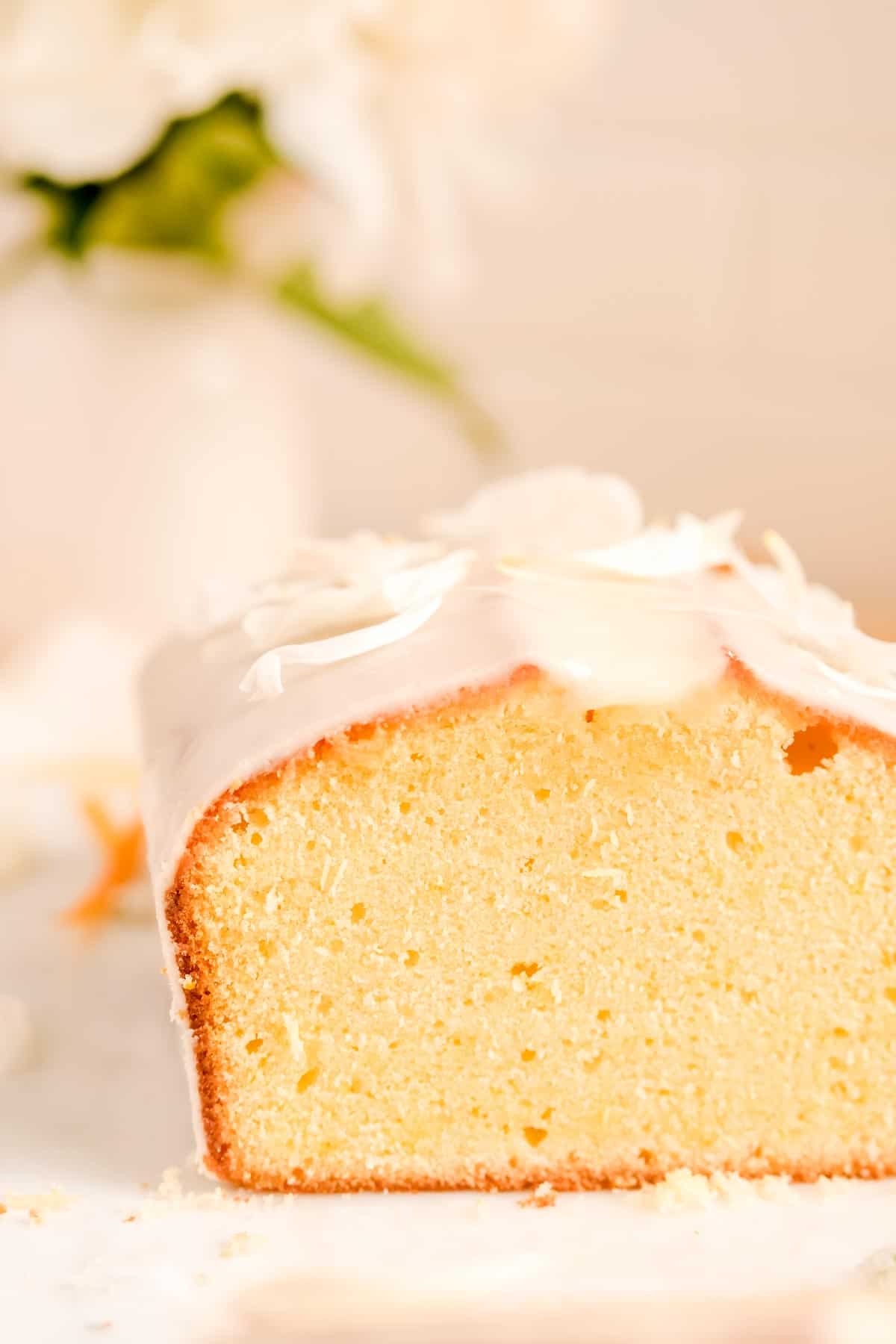 close up of sliced glazed citrus cream cheese pound cake.