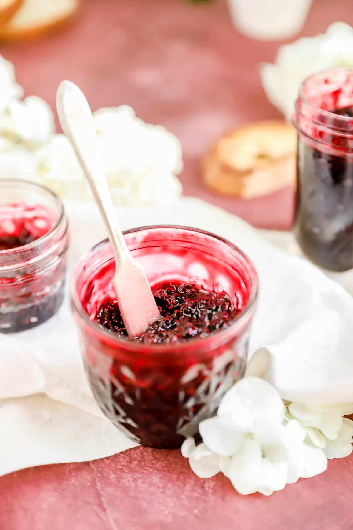 a jar of black raspberry jam from the top with a knife sticking out of it.