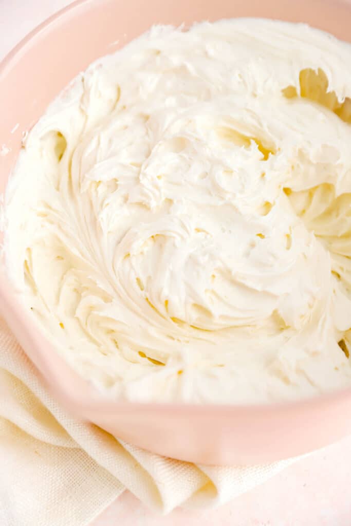 a bowl filled with freshly whipped cream cheese frosting.