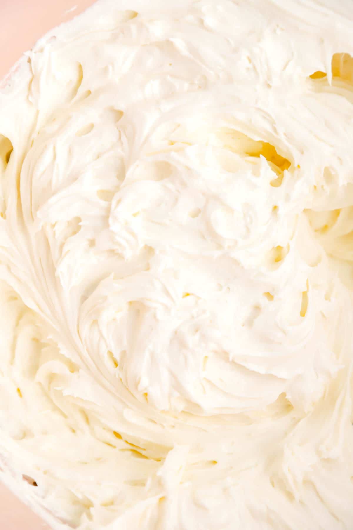 a close up of freshly whipped cream cheese frosting.