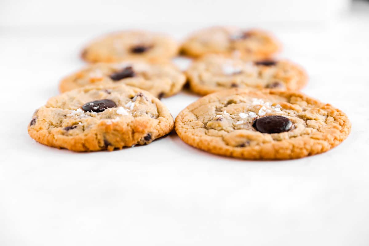 a side-view of chocolate chips cookies with a thicker one baked on convection settings