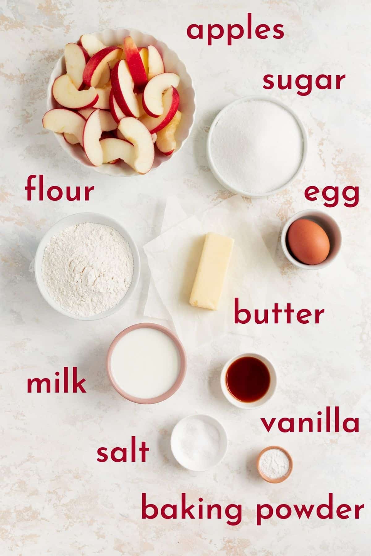 ingredients to make apple upside down cake in individual bowls on a white background