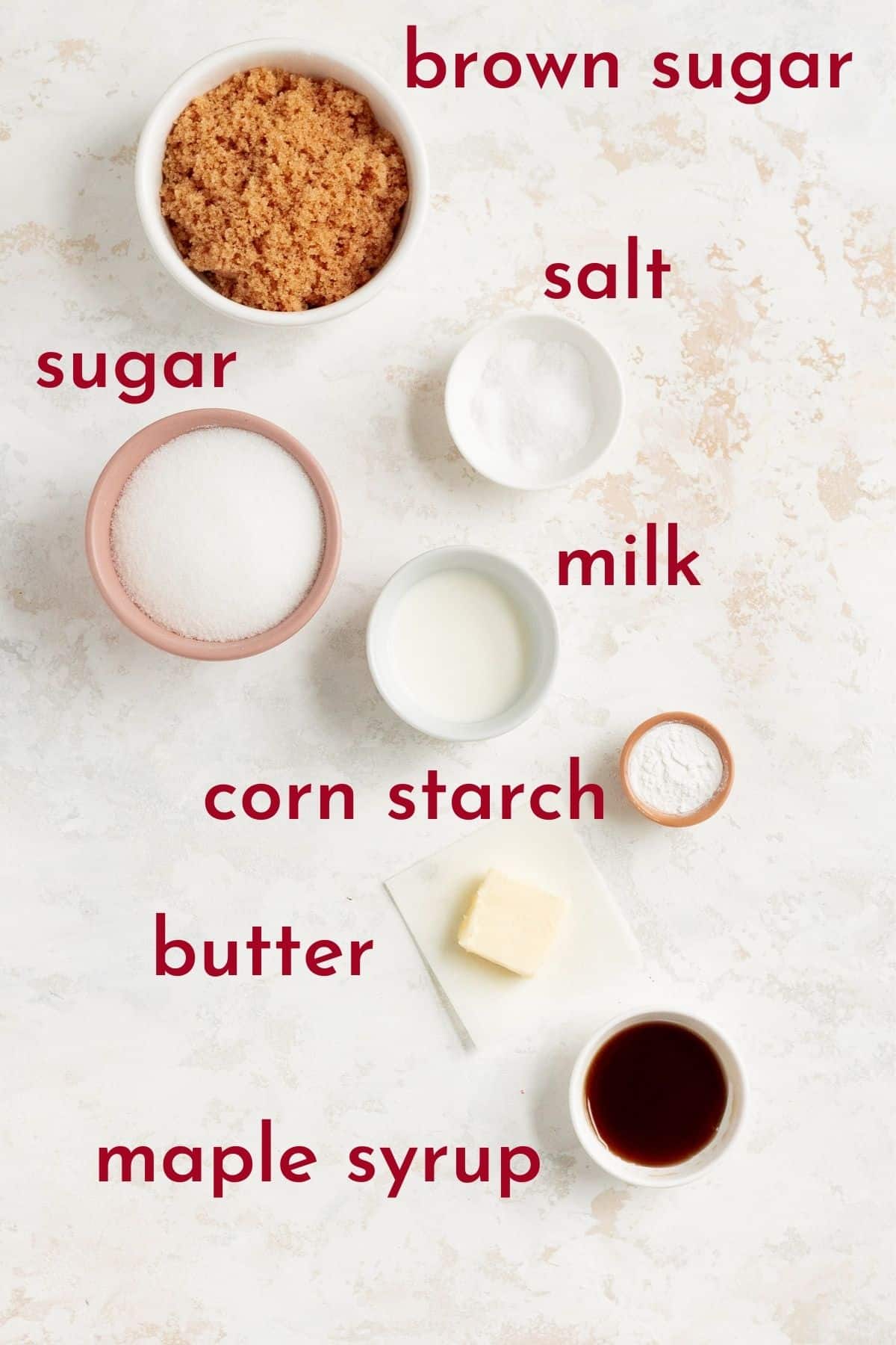 ingredients to make caramel in individual bowls on a white background