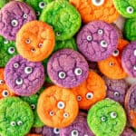 purple orange and green monster sugar cookies piled on each other