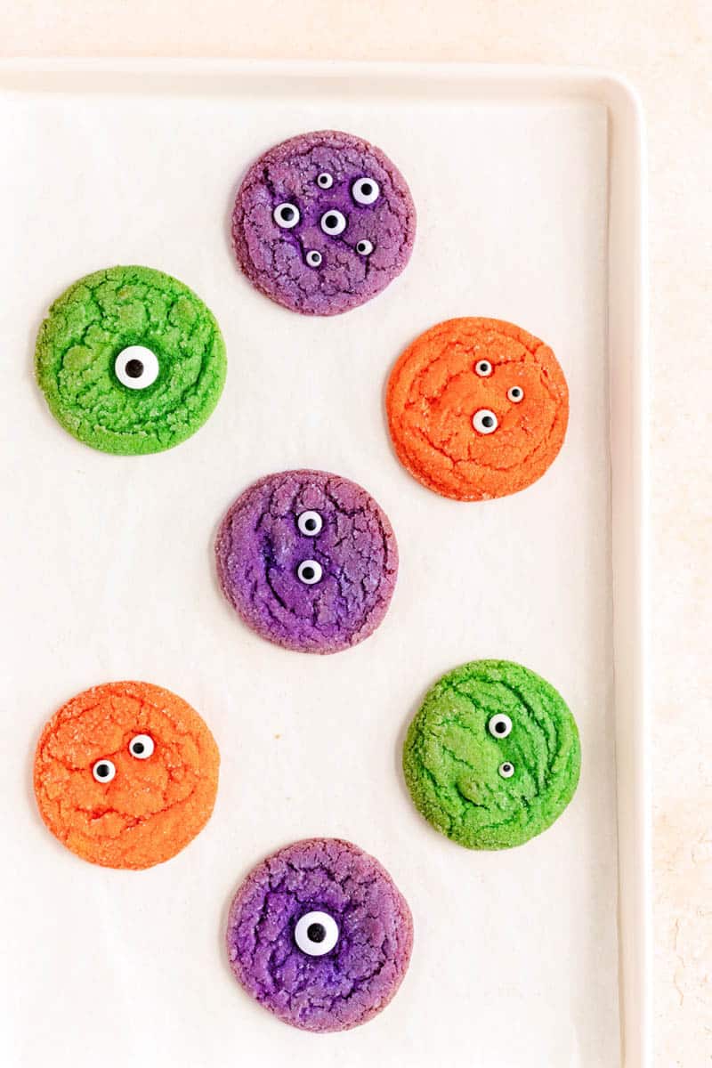 monster cookies on a white baking sheet just after they bake