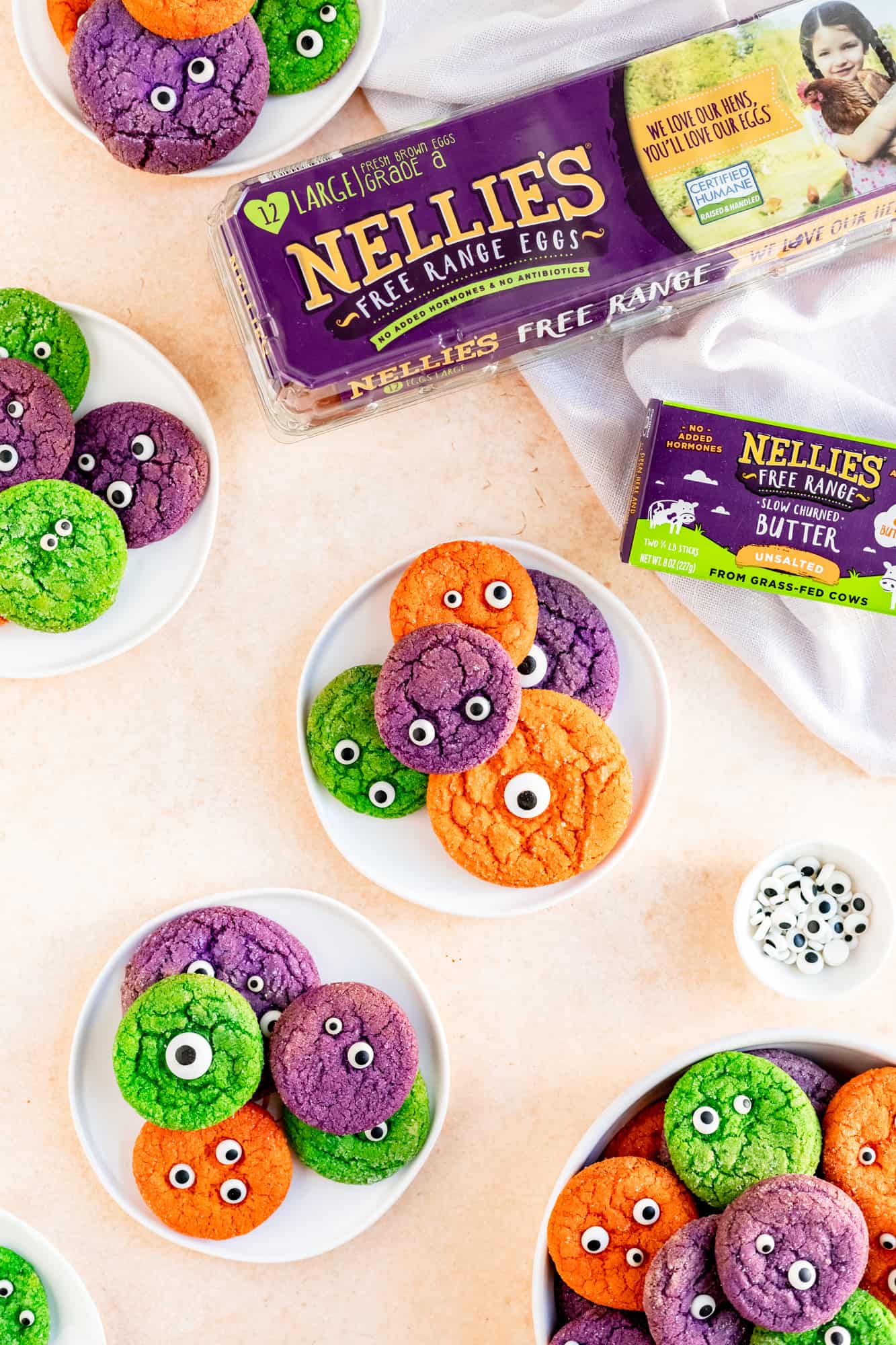 small plates and a bowl of monster sugar cookies with nellie's eggs and butter packaging