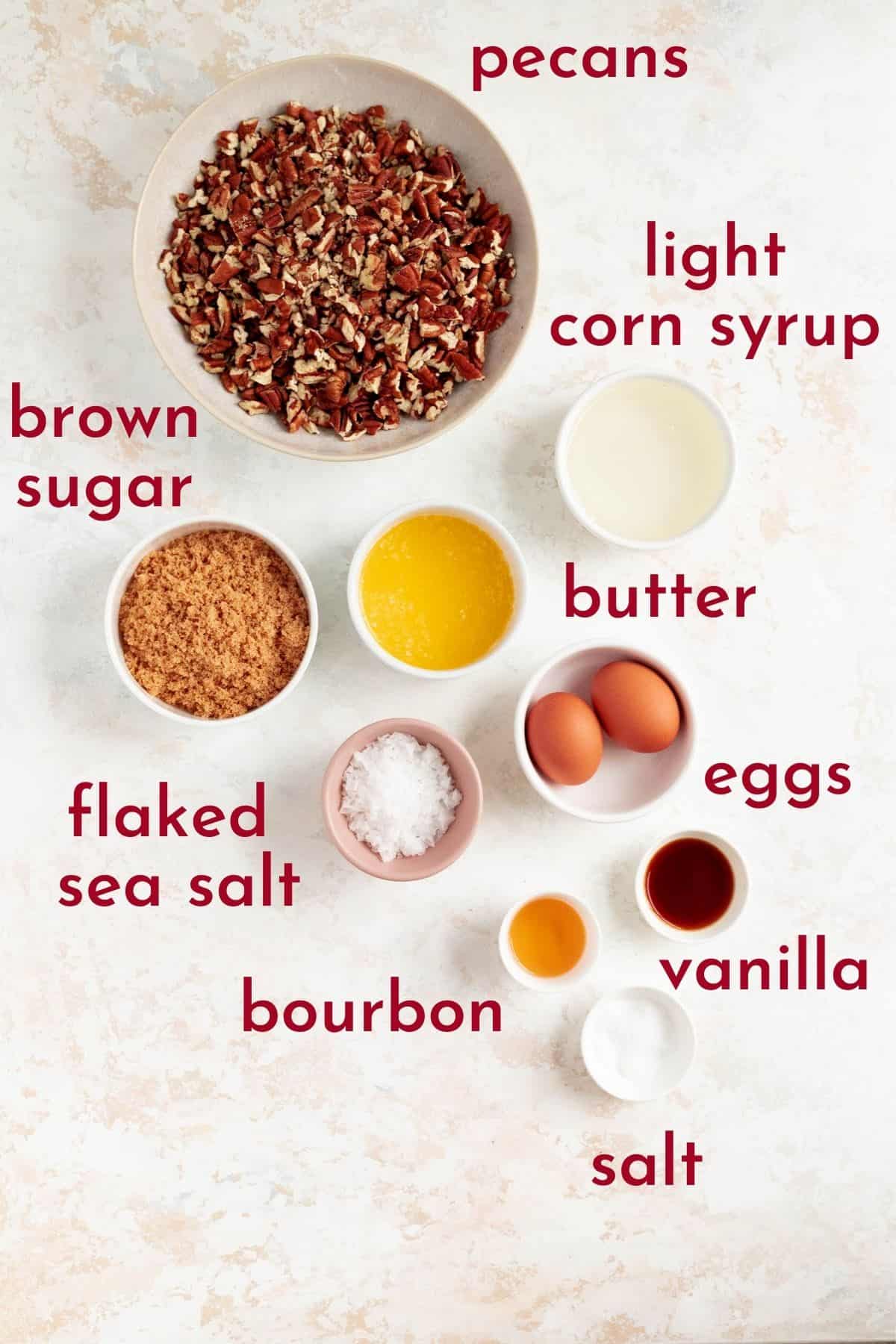 pecans, corn syrup, brown sugar, butter, sea salt, eggs, bourbon, vanilla, and salt in individual bowls.