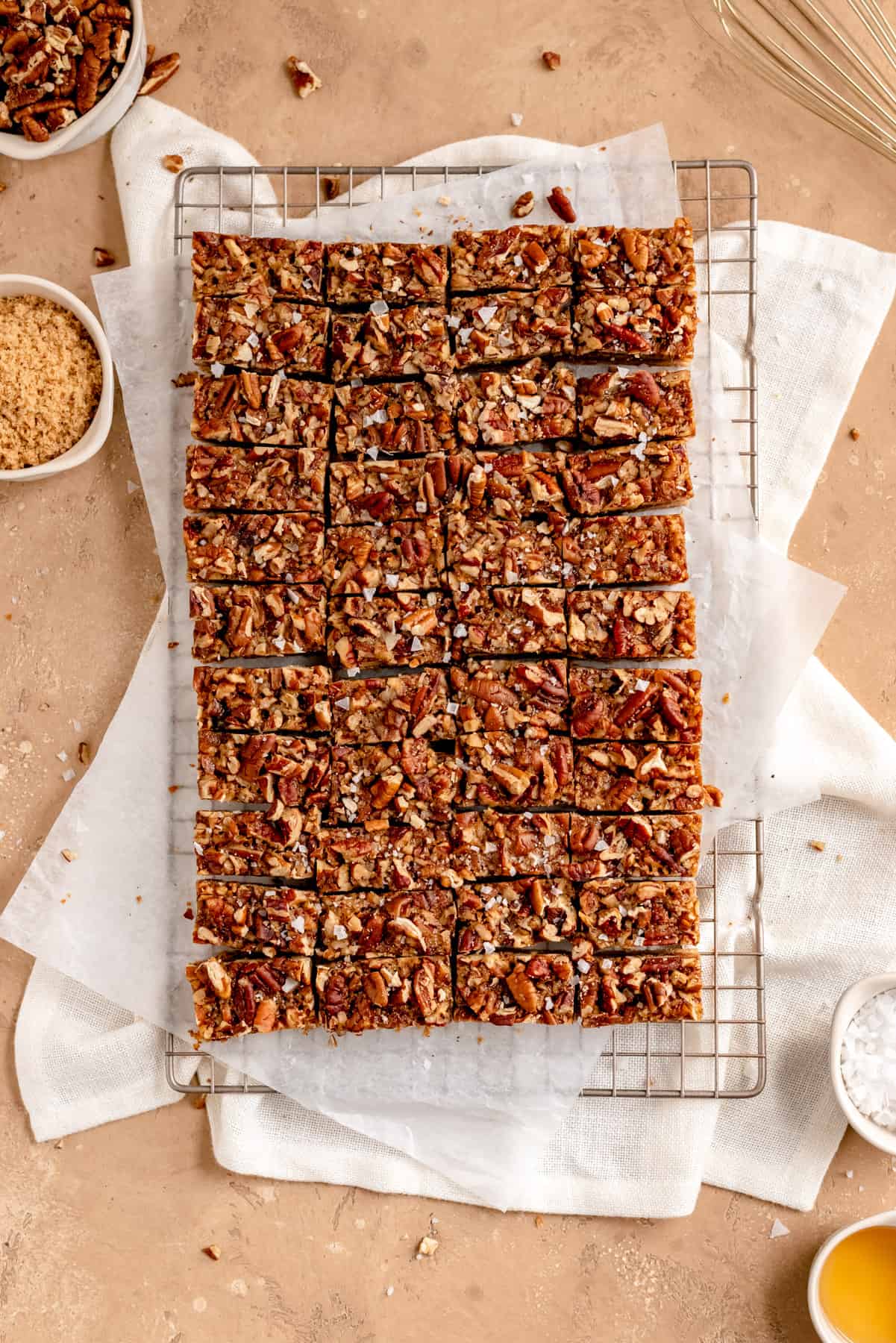an overhead view of a full pan of sliced bourbon pecan pie bars on a cooling rack