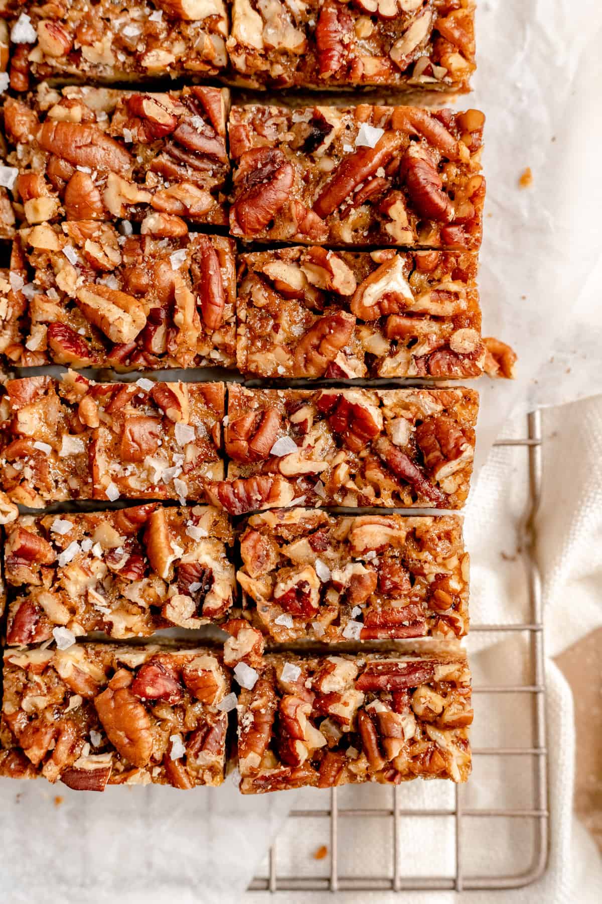 a close up overhead shot of slices pecan pie bars with salt flakes on top