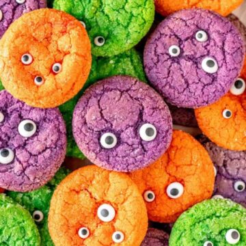 purple orange and green monster eyeball sugar cookies piled on each other