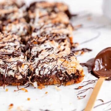 Seven layer cookie bars close up from the side showing all the layers