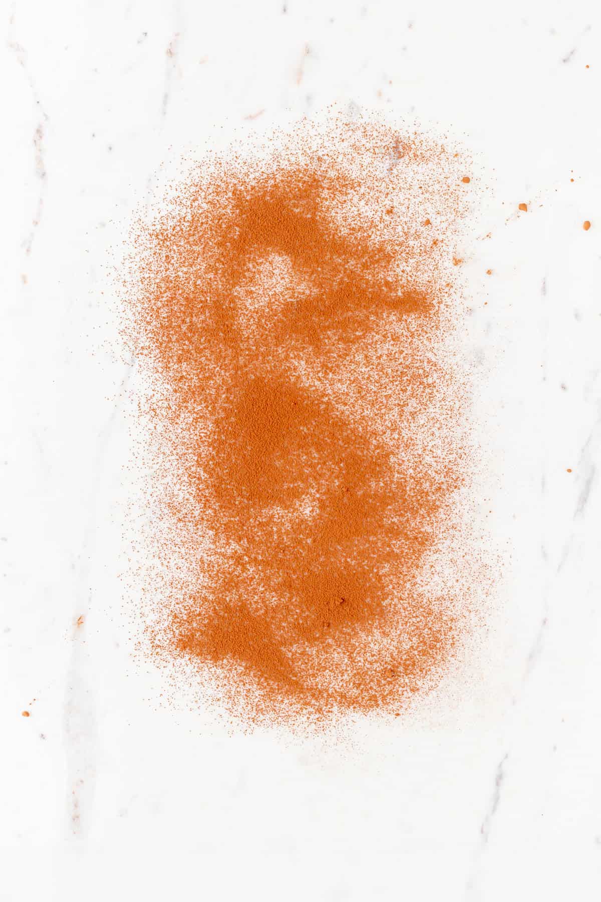 Cocoa powder dusted on a white marble surface
