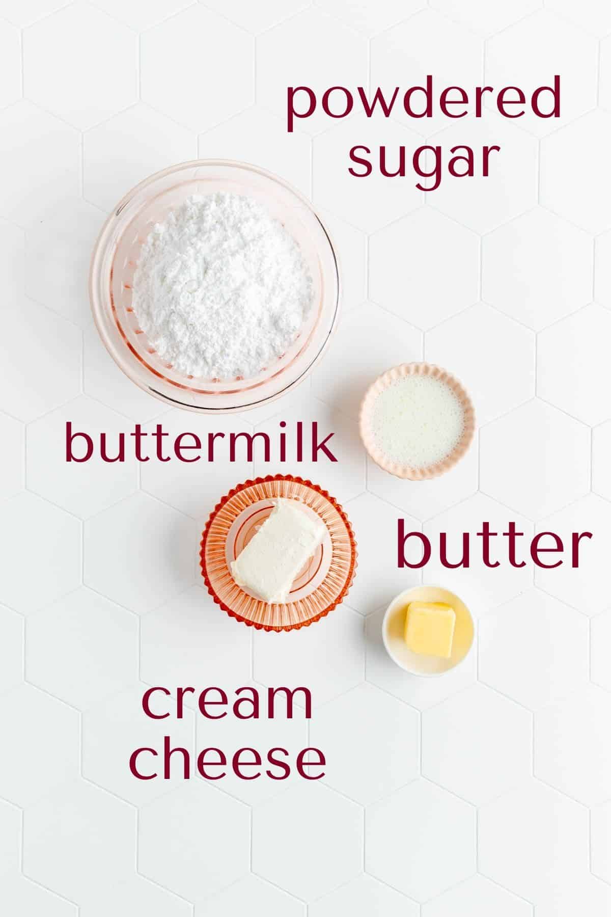 Ingredients for cream cheese glaze in individual pink bowls on white background.