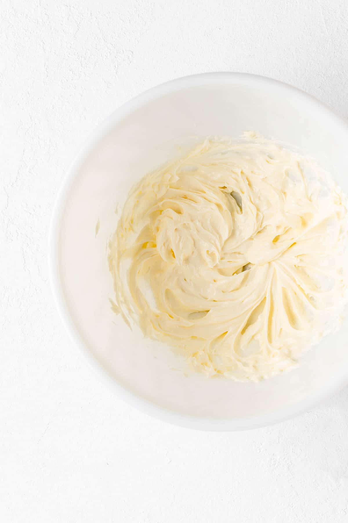 Whipped butter and cream cheese and white ball on white background.