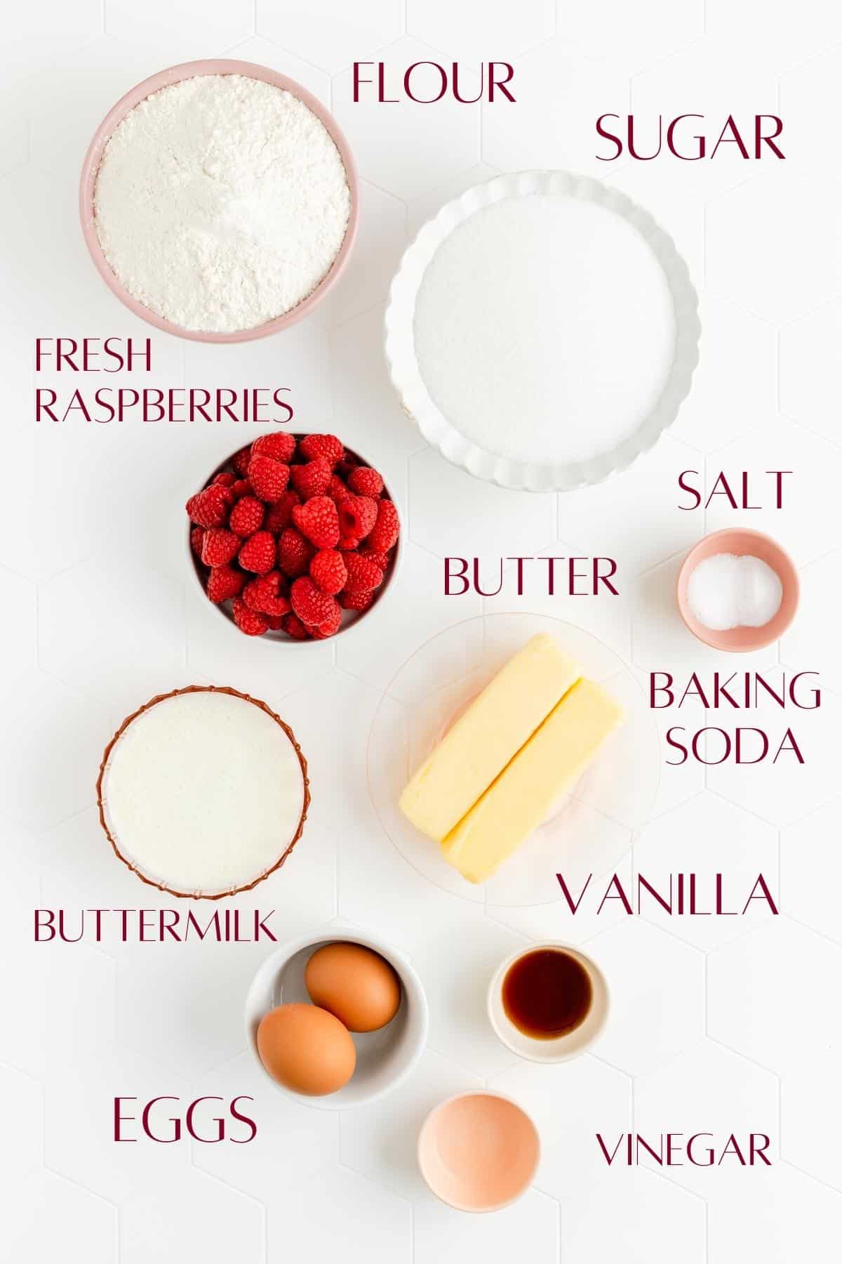 flour, sugar, raspberries, salt, butter, baking soda, buttermilk, vanilla, eggs, and vinegar in individual bowls.