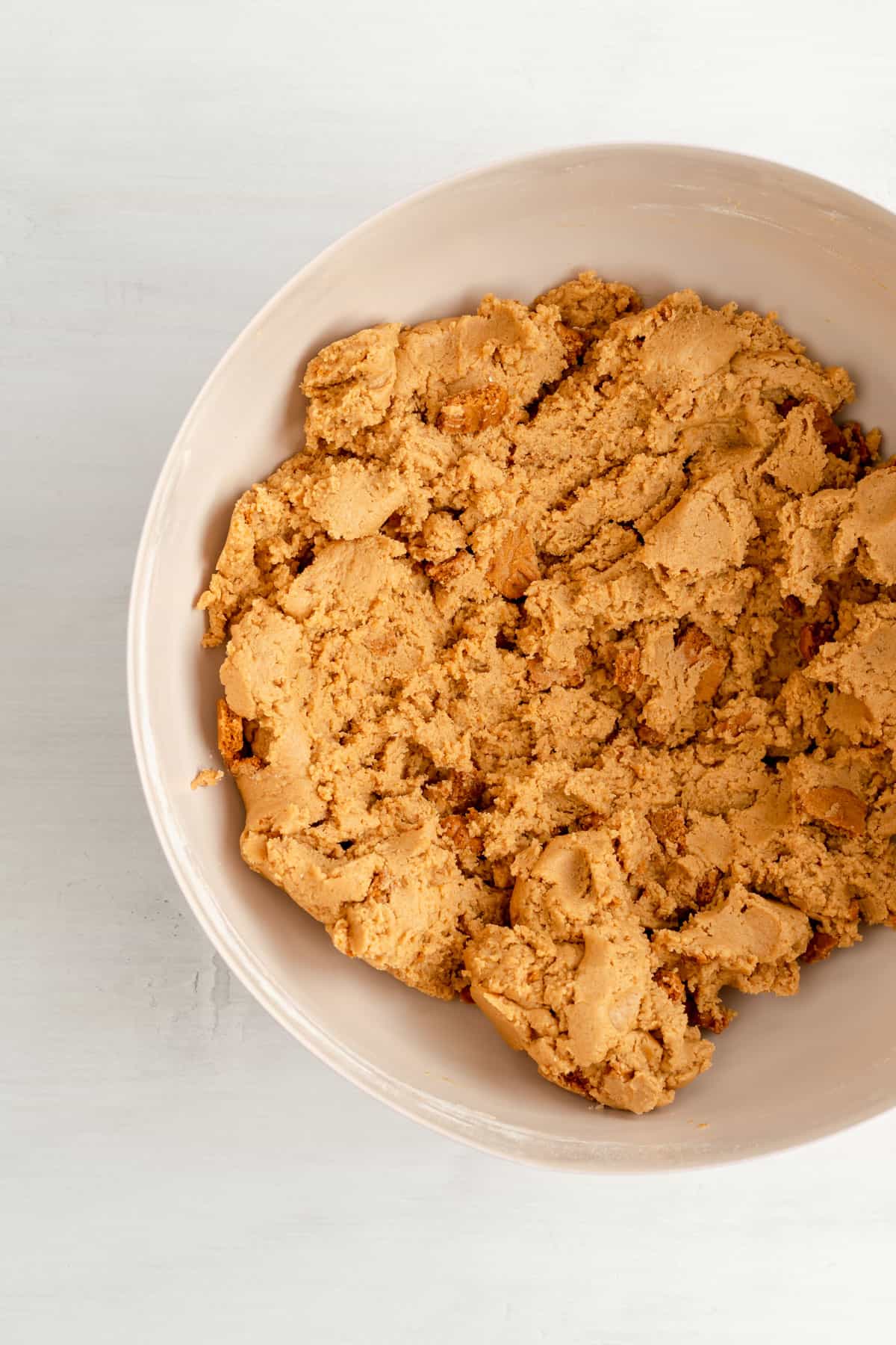 a mixing bowl of finished biscoff cookie dough with crushed cookies mixed in.