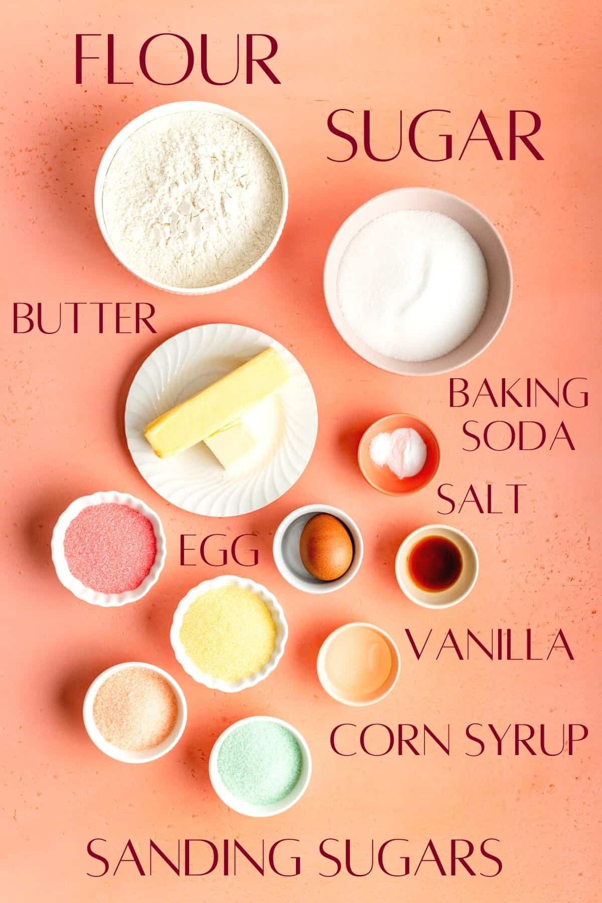 labeled sugar cookie ingredients in individual bowls on a coral background.
