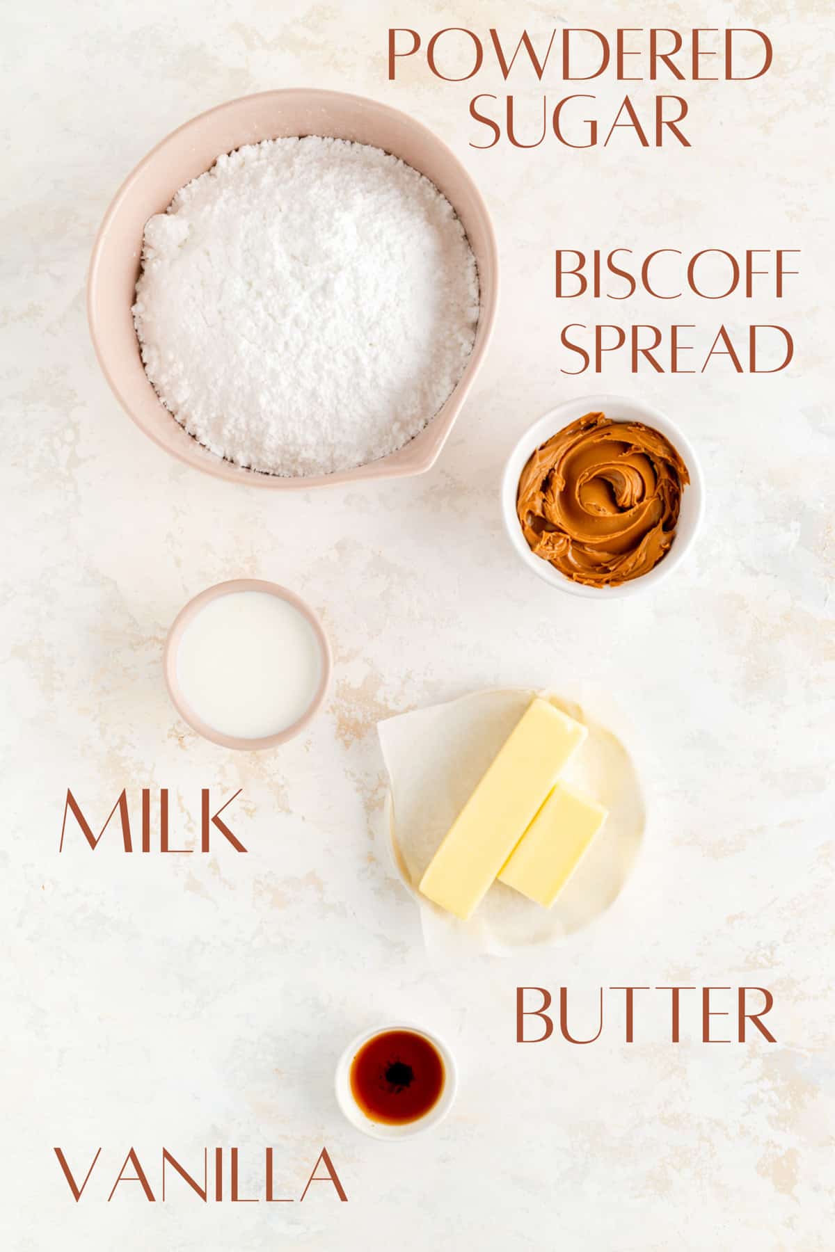Powdered sugar, Biscoff spread, milk, butter, and vanilla, in individual white bowls.
