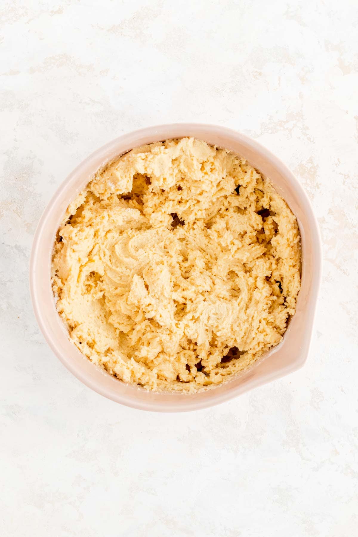 chipless cookie dough in tan bowl on white background
